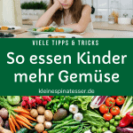 Kind, das kein Gemüse essen möchte und daher missmutig guckt und eine Vielzahl verschiedener Gemüsesorten auf einem Tisch